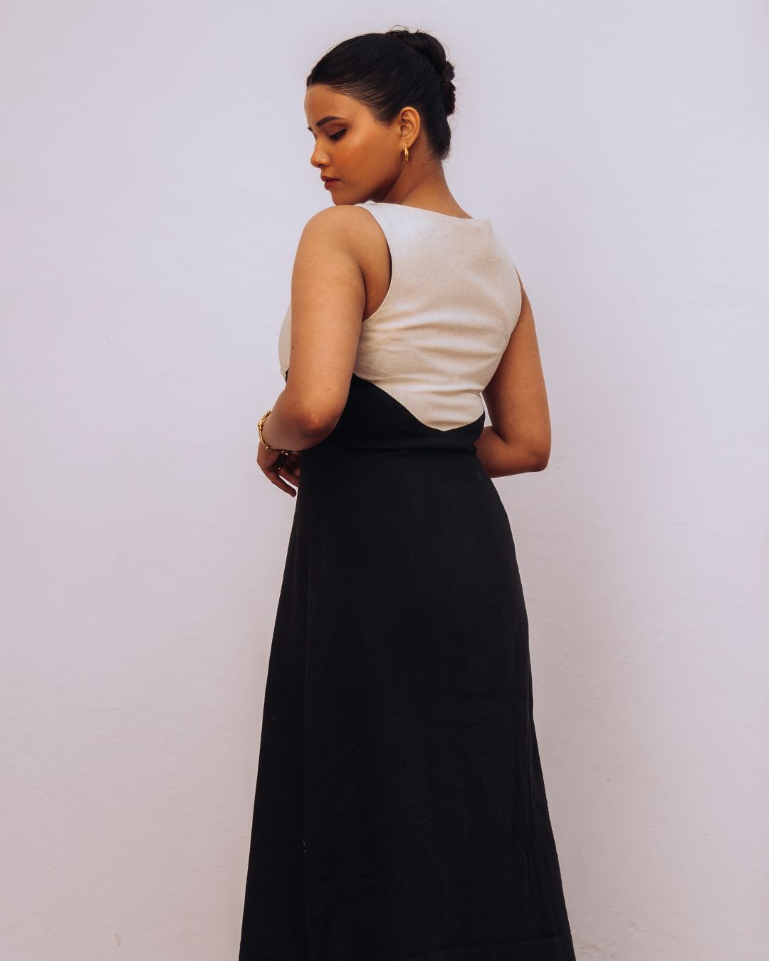 Woman wearing a two-tone dress with a white top and black skirt against a plain background Sarmad Clothing collection by sukhanvar Mehvar Dress