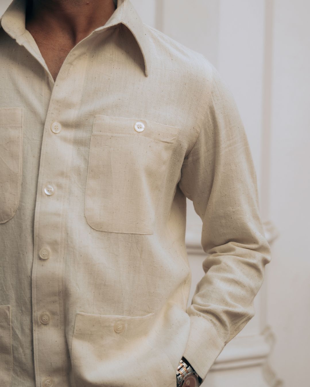 Close-up of a beige button-up shirt worn by a person. Sarmad Clothing collection by sukhanvar Mens Raavi Co ord Set 4 Pocket Shirt and Trouser Kala Cotton from kutch Bhujodi