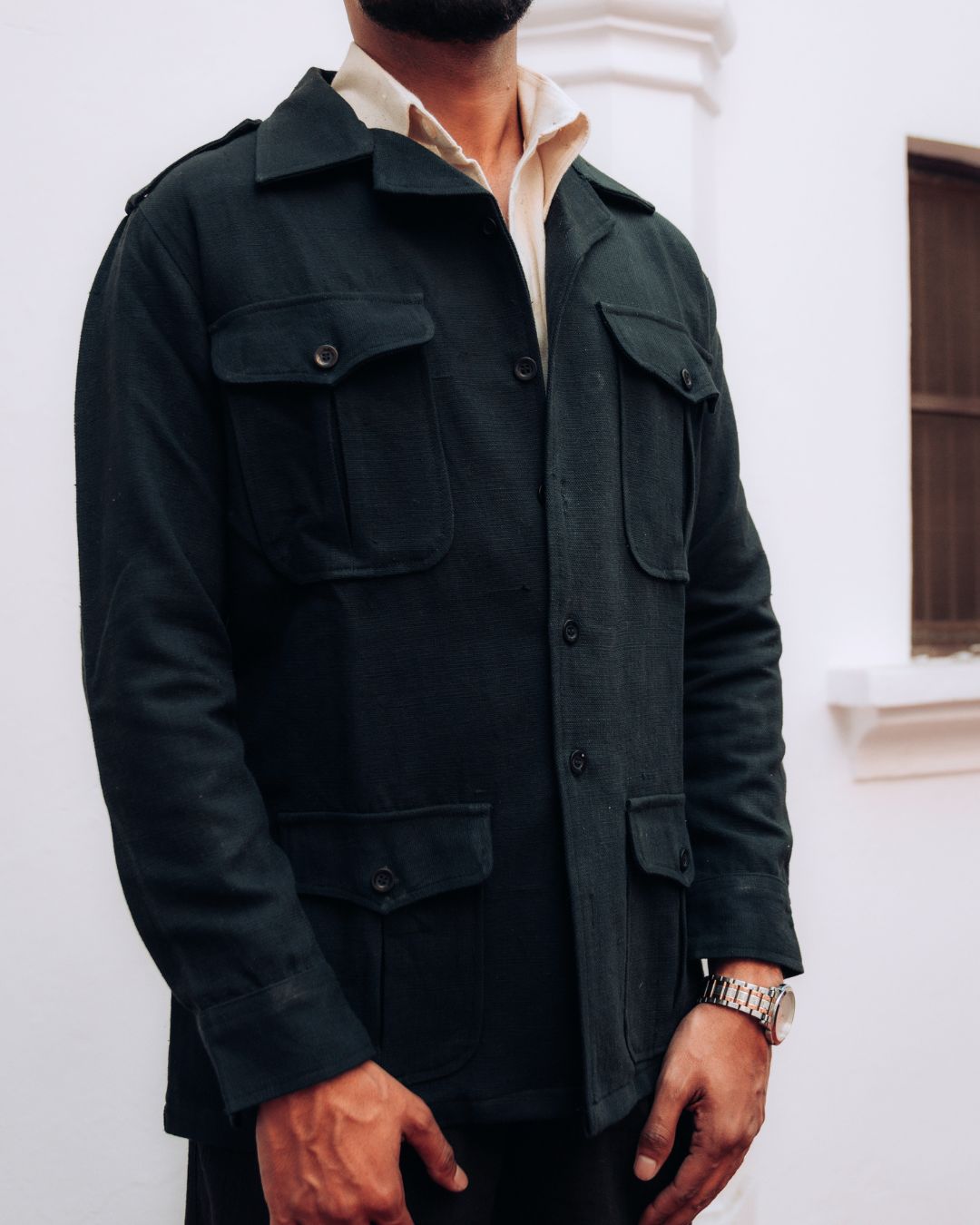 Person wearing a dark green jacket with a neutral background Sarmad Clothing collection by sukhanvar Mens Shacket jacket blazer Raahgir in Kala Cotton from kutch Bhujodi