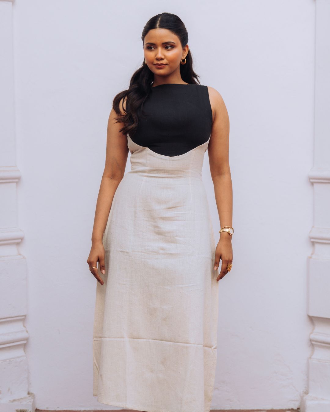 Mehvar dress Black on Ivory in Kala Cotton — Sukhanvar Sarmad SS2026. Woman wearing a black top and white skirt against a white background Sarmad Clothing collection by sukhanvar