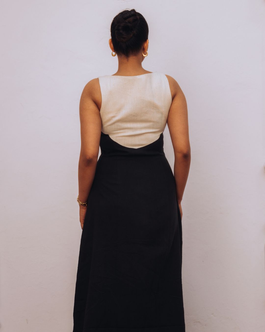 Person wearing a white sleeveless top and black skirt against a plain background Sarmad Clothing collection by sukhanvar Mehvar Dress